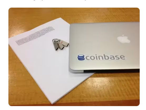 Printed key backup, USB sticks, and Coinbase laptop (Coinbase blog, 2012)